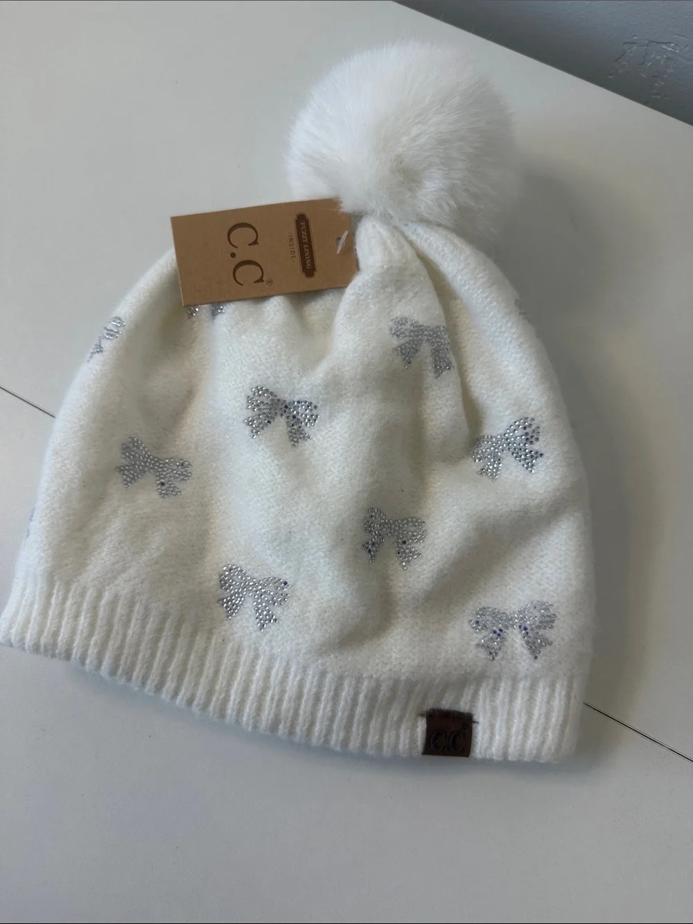 C.C Cream Beanie with Sparkling Silver Bows and Faux Fur Pom